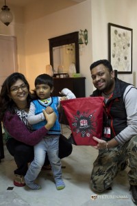 Rj Dev handing over the bag of goodies to excited Tugga