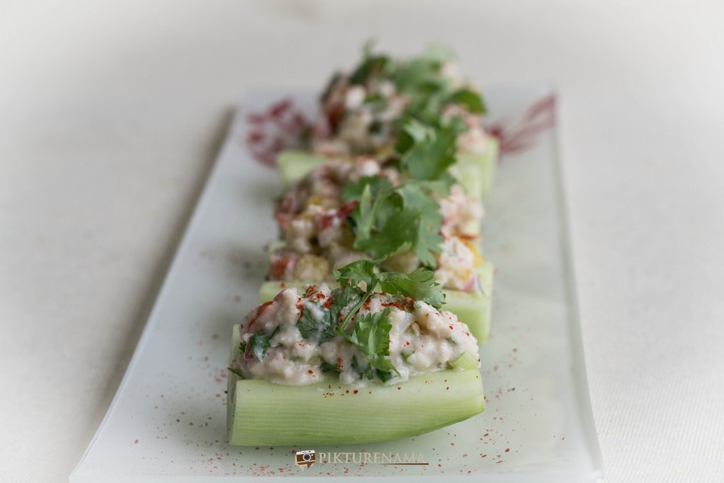 Cold crab salad in cucumber boats once ready
